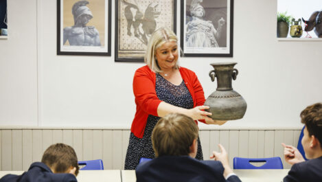 teacher holding an old pot